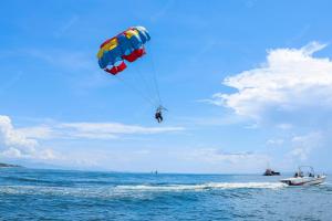 a person para sailing in the ocean with a parachute at Antigoni Hotel in Protaras