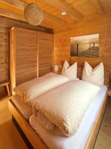 a bedroom with a bed in a log cabin at Chalet Chiemgau in Schleching
