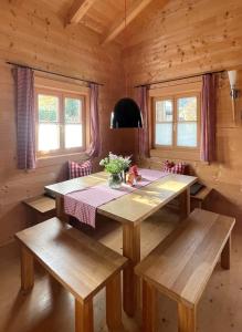 a dining room with a table and benches in a cabin at Chalet Chiemgau in Schleching