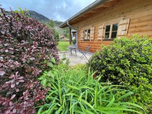 a garden in front of a wooden house at Chalet Chiemgau in Schleching