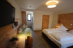 a bedroom with a bed and a flat screen tv at Gasthof Ehrl in Essing