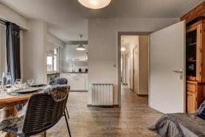 a kitchen with a table and a dining room at Appartement Halny in Les Houches