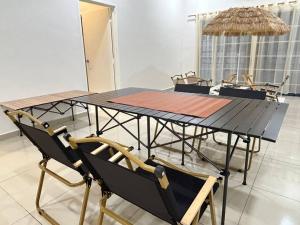a dining table and chairs in a room at Home of Camper 659 in Seremban (16-18Pax) in Seremban