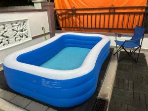 a blue and white tub on a patio with a chair at Home of Camper 659 in Seremban (16-18Pax) in Seremban