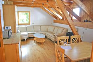 a living room with a couch and a table at Landhaus Gaisriegl in Vorderstoder