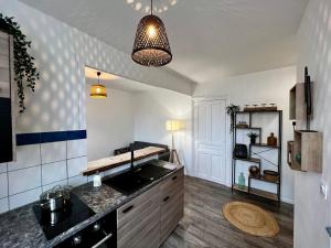 a kitchen with a sink and a stove at Home Sweet Home in Roanne +14 photos