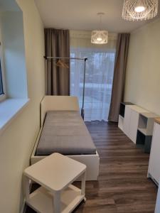 a small room with two beds and a window at J55 Apartments in Riga