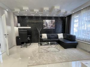 a living room with a couch and a desk at Luxury Central Apartment Verila in Sofia