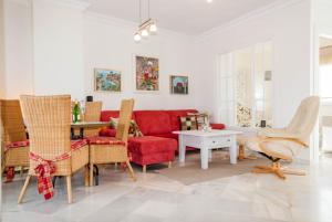 a living room with a red couch and chairs at Stella Maris B4 3A Nerja in Nerja