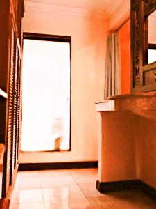 an empty room with a door and a window at Sahadewa Resort & Spa in Ubud