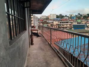 a balcony of a building with a view of a city at K&GTransient House in Baguio