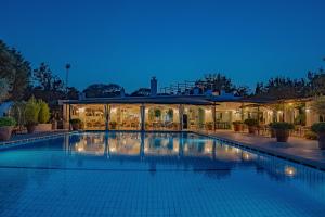 a large swimming pool in a building at night at Botania Relais & Spa - The Leading Hotels of the World in Ischia