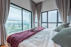 a bedroom with a bed with a large window at Reizz Residence By Minsu in Kuala Lumpur