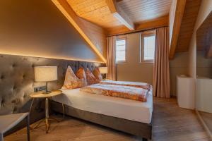 a bedroom with a bed and a table and a window at Ski Dome Apartments & Heaven Holiday Chalet in Kaprun