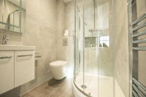 a bathroom with a toilet and a glass shower at Chester House in Reading