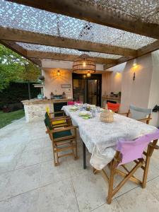 a dining table with chairs and a kitchen in the background at Villa Helios in Pefkochori +32 photos