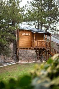 a wooden cabin with a balcony on a wall at La Moara Boutique Hotel in Kraniá