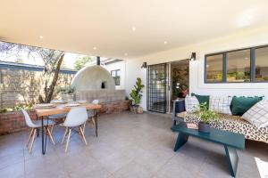 a living room with a table and a couch at No 1 Dicks Street Apartment in Howick