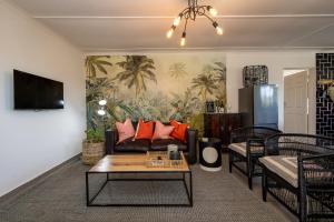 a living room with a couch and a table at No 1 Dicks Street Apartment in Howick