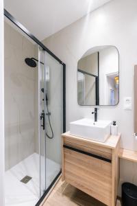 a bathroom with a shower and a sink and a mirror at Luxury flat next to Gran Via Madrid in Madrid