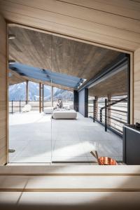 a living room with a large glass window at OVINA`s HAUS in Sand in Taufers