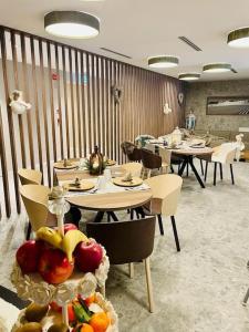 a restaurant with tables and chairs with fruit on display at Luxury apartment with pool, sauna, SPA in Champoluc