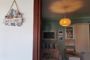 a living room with a couch and a light fixture at Casa Azzurra con vista Mare in Ustica