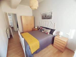 a bedroom with a bed with a yellow and blue blanket at Quiroga centro paradise in Quiroga