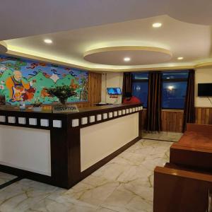 a lobby with a bar with a colorful wall at Hotel Royal Gangtok in Gangtok