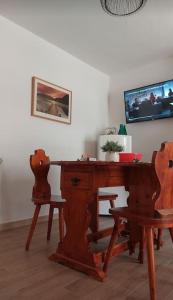 Appartamento Residence Monte D'Ocre في روكا دي كامبيو: طاولة خشبية قديمة وكرسيين في الغرفة