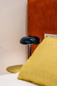 a blue stool next to a bed with a pillow at SUNSET MALAGA Exclusive Alameda in Málaga