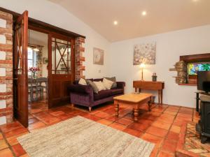 a living room with a couch and a table at The Shippen in Bude