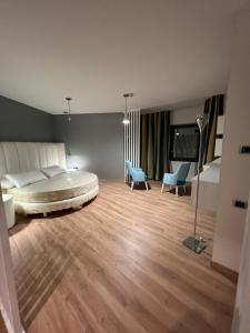 a large bedroom with a bed and two chairs at Park Hotel Mirabeau in Montepaone