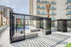 a gate in front of a building at Vibrant 1BR in Bella Rose Al Barsha South by Deluxe Holiday Homes in Dubai