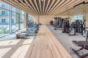 a gym with treadmills and exercise equipment in a building at Vibrant 1BR in Bella Rose Al Barsha South by Deluxe Holiday Homes in Dubai
