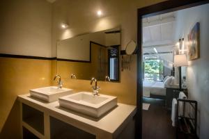 a bathroom with two sinks and a large mirror at Villa Aurora, Galle Fort in Galle