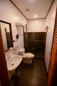 a bathroom with a sink and a toilet and a shower at Casa Simeon in Bacacay