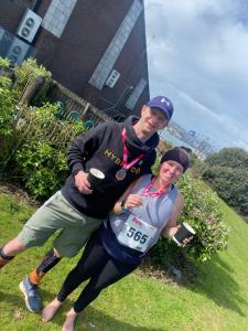 a man and woman posing for a picture after a race at Gwens Garden bell tent in St. Just +4 photos