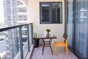 a balcony with a table and a chair at GTC 1Br Apartment on Westlands Road -with Gym& Pool in Nairobi