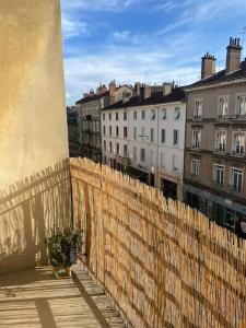 a fence in front of a city with buildings at Studio avec Balcon proche Gare in Bourg-en-Bresse
