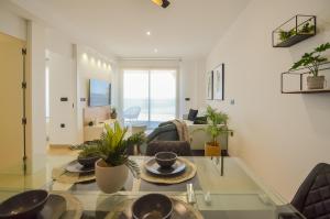 a living room with a glass table with plants on it at 136 Luxury Sea View - Alicante Holiday in La Mata