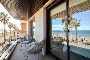 a view of the beach from the balcony of a beach house at 136 Luxury Sea View - Alicante Holiday in La Mata