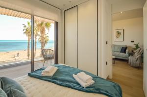 a bedroom with a bed with a view of the beach at 136 Luxury Sea View - Alicante Holiday in La Mata