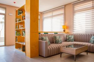 a living room with a couch and a book shelf at Valley Boutique Hotel in Safi