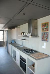 a large kitchen with a stove top oven in it at house λ in Skiathos