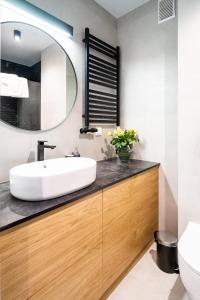 a bathroom with a sink and a mirror at Apartament Górska Polana by Apart Concept Podhale in Kościelisko