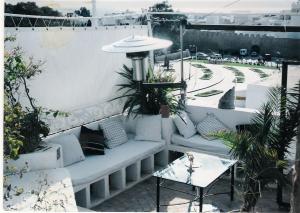 a white couch sitting on the side of a building at la casbah in Hammamet