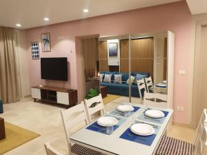 ein Esszimmer und ein Wohnzimmer mit Tisch und Stühlen in der Unterkunft Mangroovy - 1BR GF +2 wall beds Garden & Pool view in Hurghada