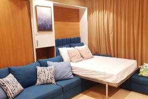 1 cama y 1 sofá en una habitación en Mangroovy - 1BR GF +2 wall beds Garden & Pool view, en Hurghada