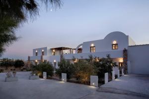 a large white building with lights in front of it at New Villa Katerina Collection in Megalokhori